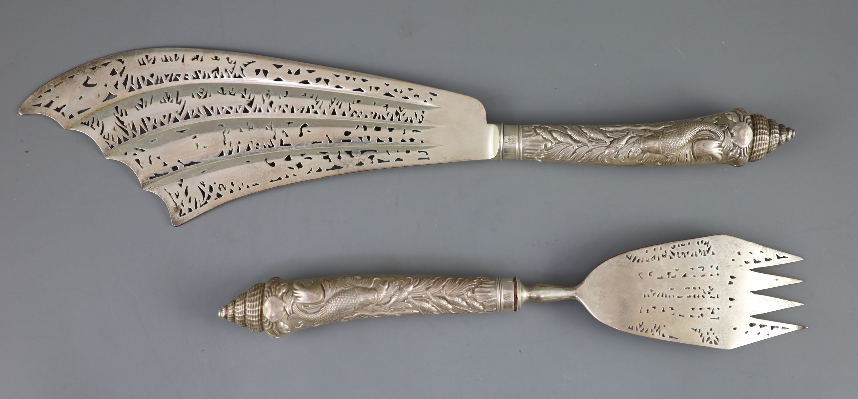 A cased ornate pair of Victorian silver fish servers, Aldwinckle & Slater